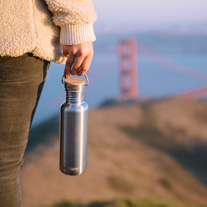 27oz-reflect-with-bamboo-cap-y2 K27SSLRF-BS-BAMBOO_reflect_bottle_bridge_lifestyle.jpg