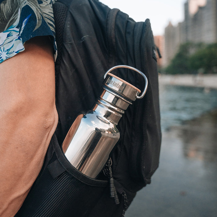 27oz-reflect-with-bamboo-cap-y2 K27SSLRF-MS-BAMBOO_reflect-bottle_backpack_lifestyle.jpg